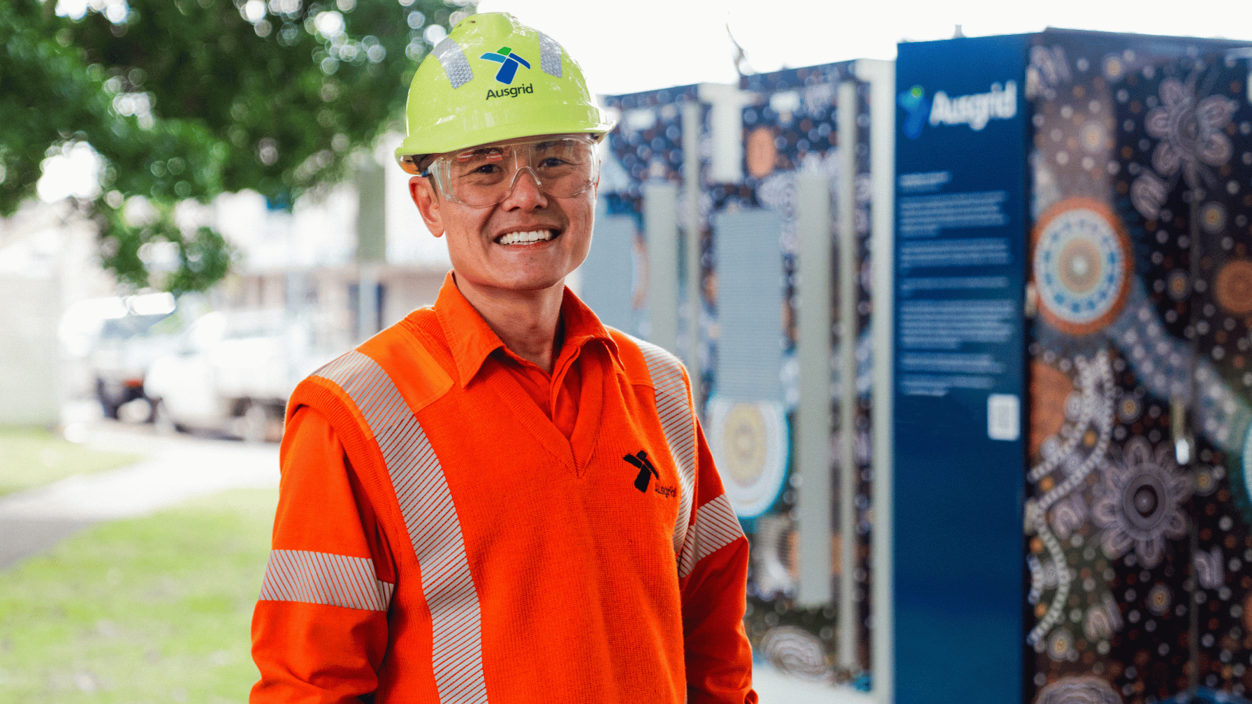 Ausgrid worker standing in front of a community battery