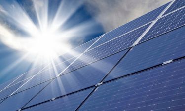 solar panels with sun shining