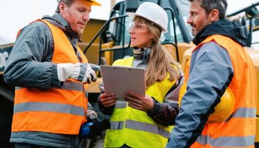 Construction workers checking plans