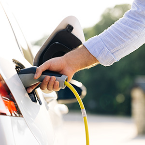 Man charging an Electric Vehicle