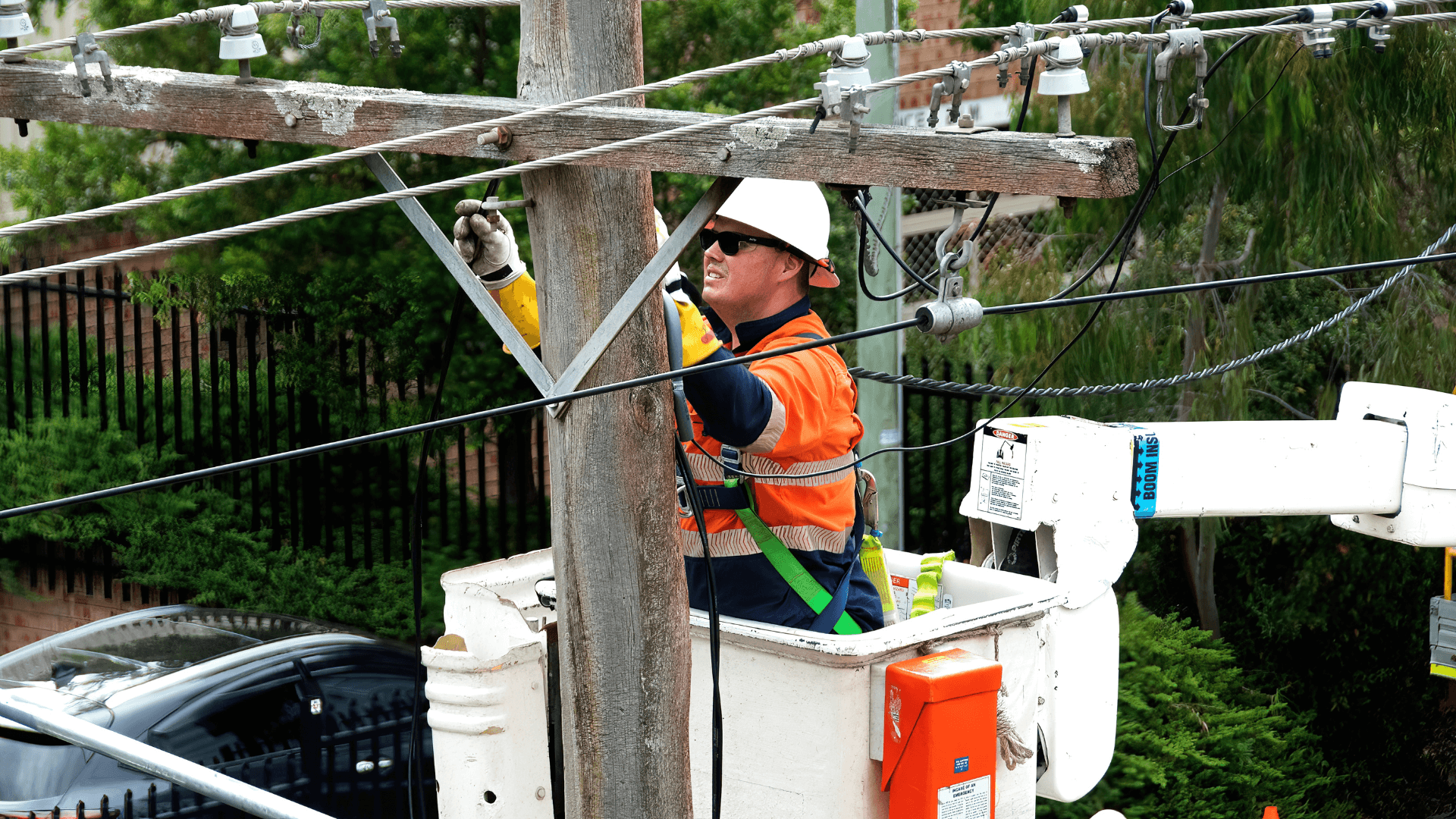 Certified contractor working on pole in bucket